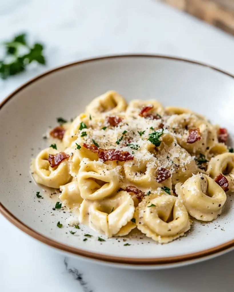 u6472731739 plated creamy tortellini carbonara with bacon and 1bdc30cc 1d21 4125 ad0f c643cfdbdb6c 3 30 Minute Creamy Tortellini Carbonara Recipe