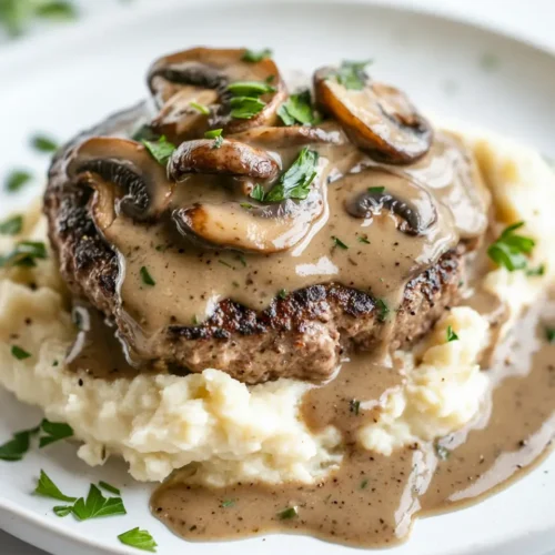 u6472731739 plated keto burger steak topped with creamy mushr d4b6bd87 8254 4802 8134 c1174839b7b9 1 Keto Burger Steak with Mushroom Gravy: A Low-Carb Southern Comfort Classic